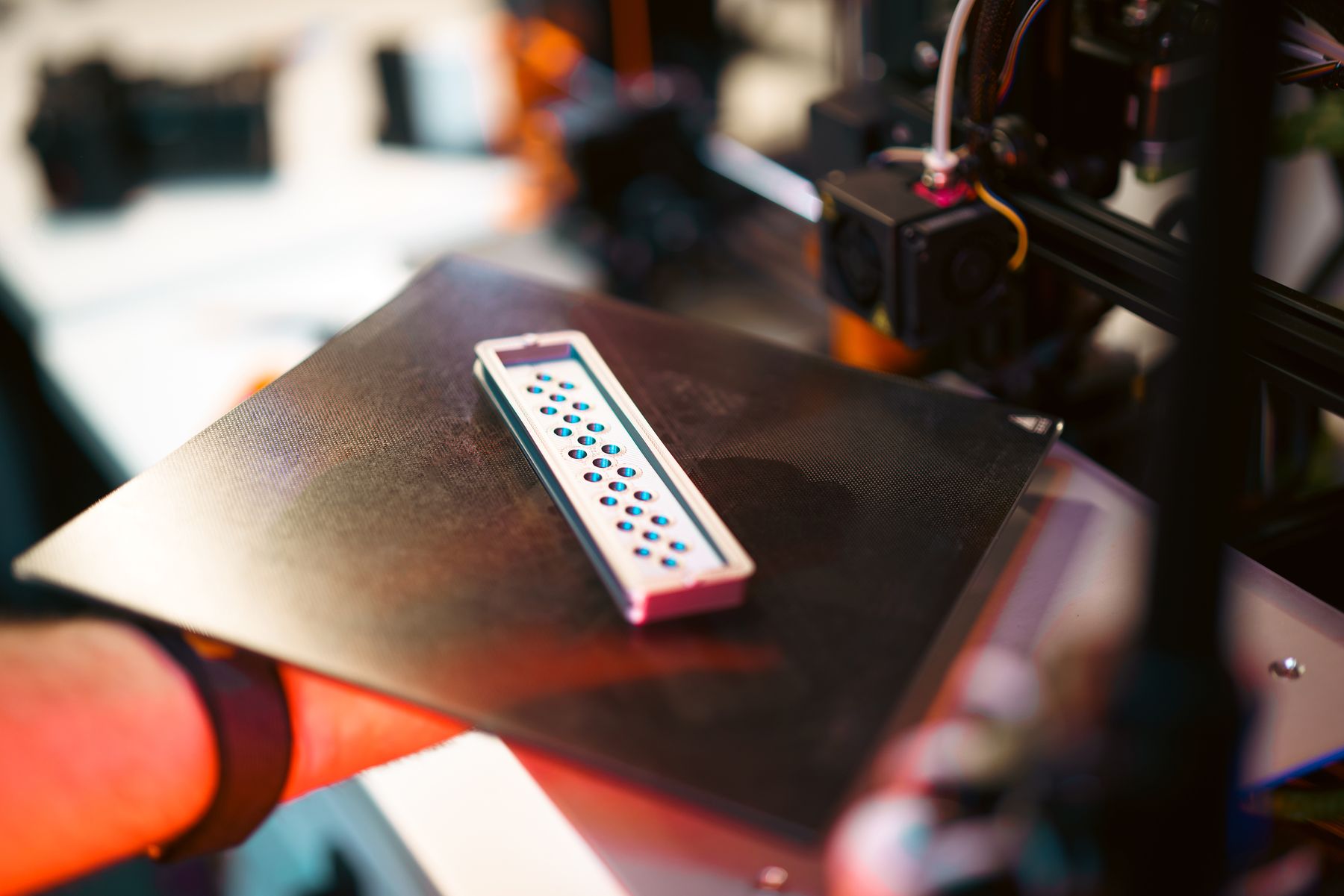 Functional part being produced on a 3D printer in a workshop